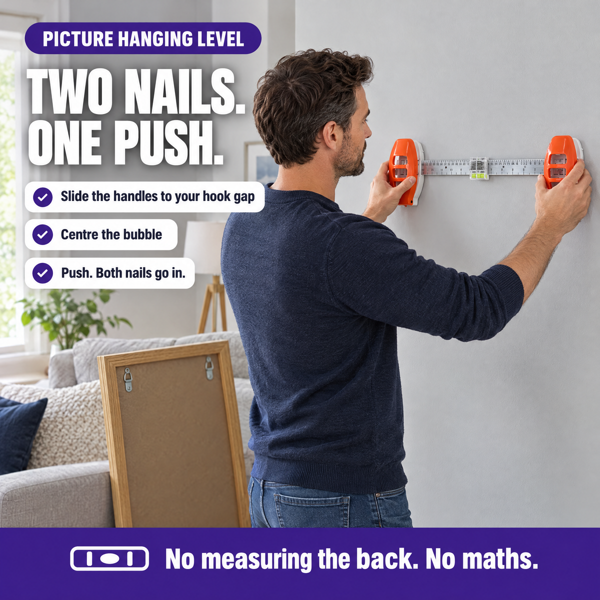 Man holding the picture hanging level against a wall